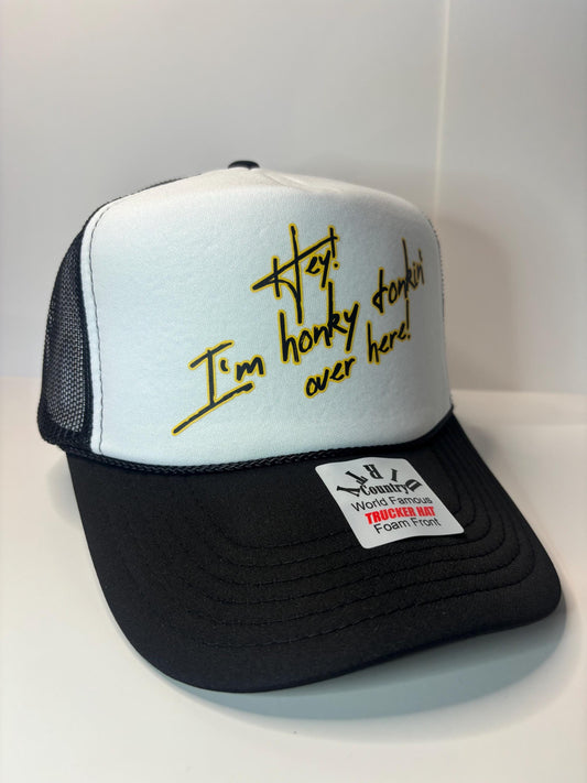 Hey I’m Honky Tonkin’ over here Custom Trucker Hat with parody design, Adjustable Snapback Closure, and Ideal for Any Occasion