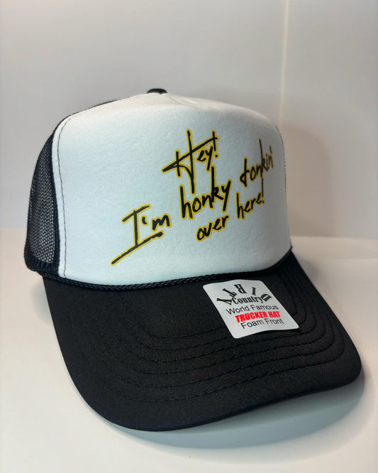 Hey I’m Honky Tonkin’ over here Custom Trucker Hat with parody design, Adjustable Snapback Closure, and Ideal for Any Occasion